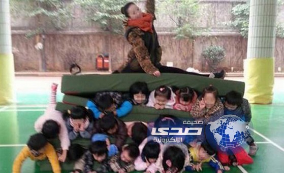 صورة لمعلمة وهي تجلس فوق تلاميذها تثير الجدل