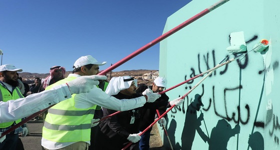 بالصور.. أمانة عسير تنفذ برنامج ” طمس الكتابات “