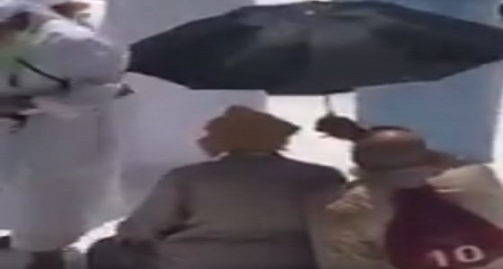 بالفيديو.. شاب يخفف عن والده حرارة الجو وهو يصلي بالمسجد الحرام