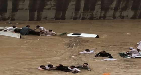 مواطنون يحاولون إنقاذ عائلة غرقت سيارتهم في نفق طريق ديراب