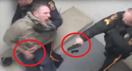 بالفيديو والصور.. ضابط يطلق النار على متهم داخل غرفة الاحتجاز 