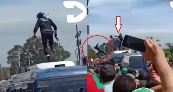 بالفيديو.. متظاهرون يرمون رجل أمن من فوق سيارة شرطة بالشارع