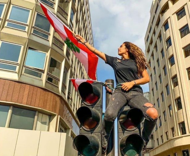 فتاة لبنانية تتسلق إشارة المرور