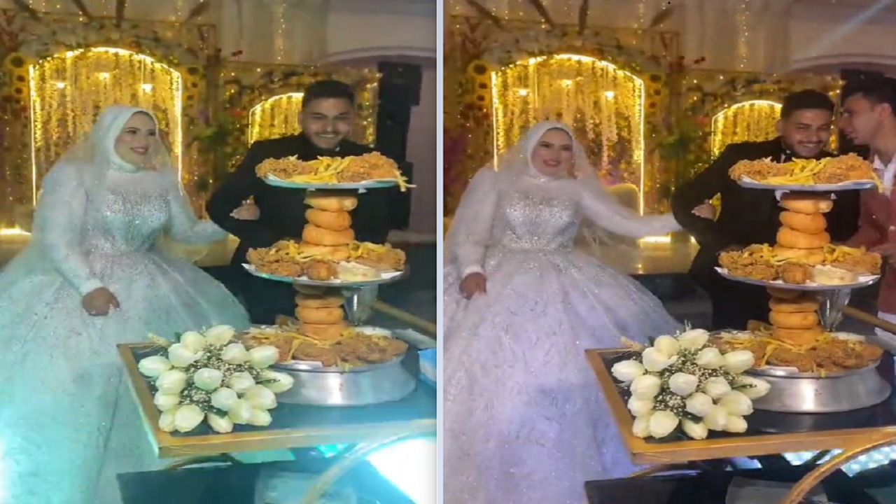 عروسان يستبدلان الكعك بالبروستد في حفل زفافهما..فيديو