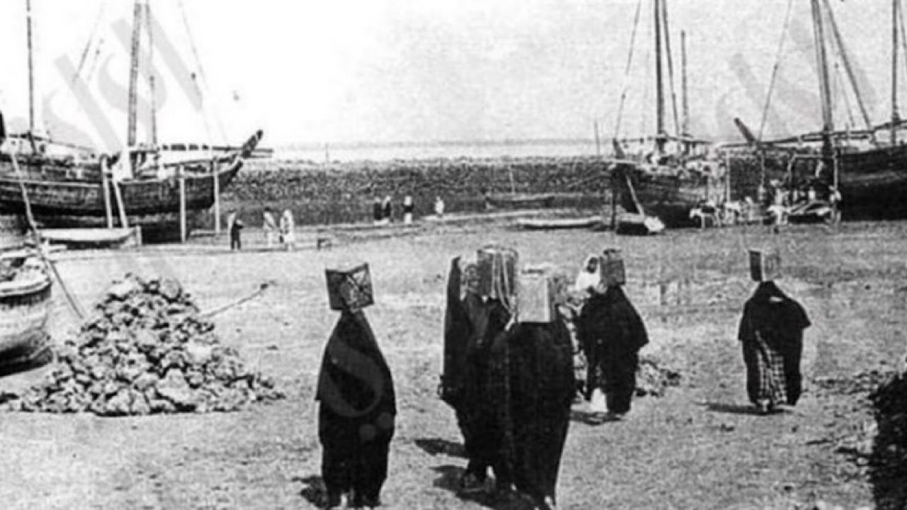 صورة تاريخية لم يمحها الزمن لنساء الكويت يحملنَ على رؤوسهنَ الماء من القوارب