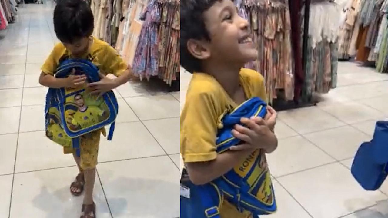 مشهد رائع لفرحة طفل بحصوله على حقيبة بصورة رونالدو ويحتضنها .. فيديو