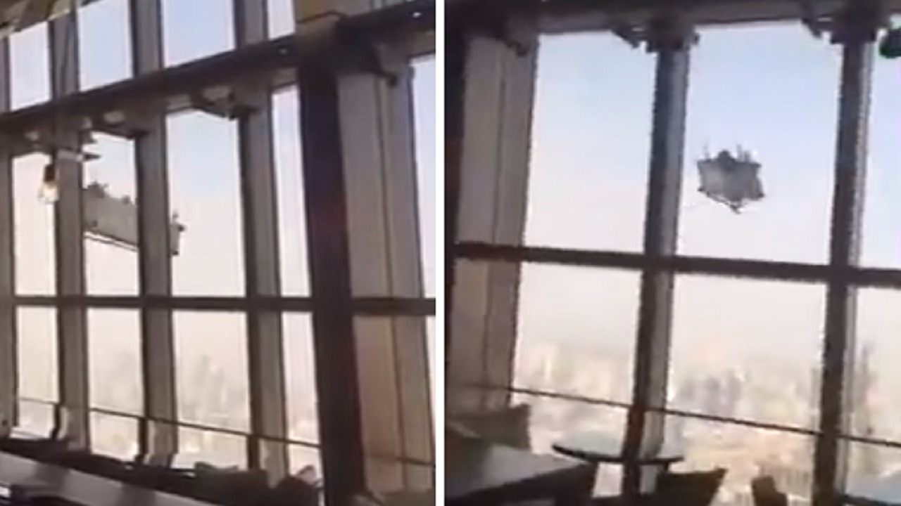 بالفيديو .. عمال نظافة يتأرجحون في الهواء من الطابق 92